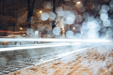 road city traffic in winter snowstorm night