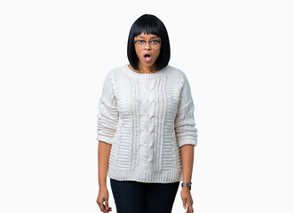 Beautiful young african american woman wearing glasses over isolated background afraid and shocked with surprise expression, fear and excited face.