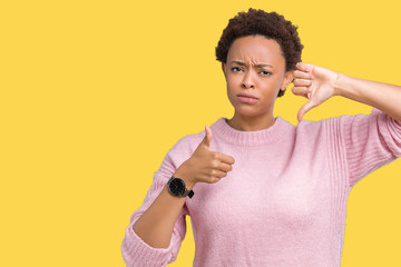 Beautiful young african american woman over isolated background Doing thumbs up and down,...