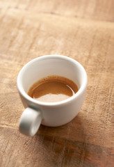 Cup of coffee on rustic wooden background. Copy space.