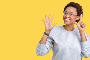 Young beautiful african american woman wearing glasses over isolated background showing and pointing up with fingers number seven while smiling confident and happy.