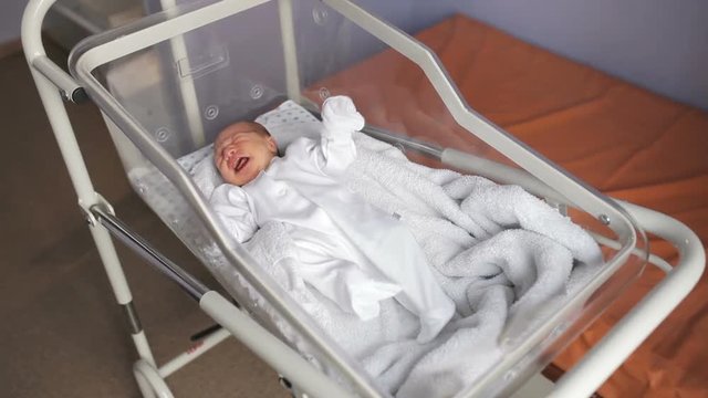 Newborn baby girl in maternity hospital