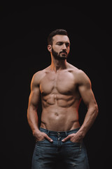 muscular shirtless macho posing isolated on black