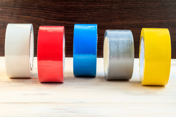 Several rolls of duct tape. stand and roll towards us. have toning. shallow depth of cut.