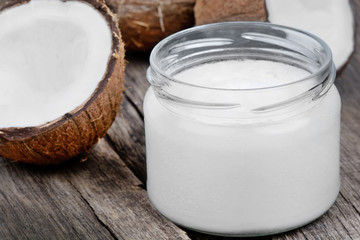 Coconut oil in a jar and fresh coconuts