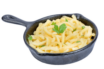Pan with spatzle with butter and parsley on white background