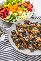 Fototapeta na wymiar Fresh mixed salat with herbs and mushrooms