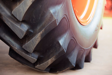 Close up of tractor tire,Modern Tractor with Big Wheels sunlight toned 