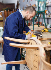 Carpenter repairing antique chair