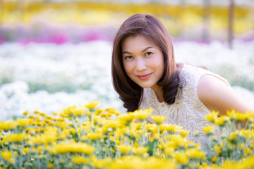 Beautiful Asian woman in tropical flower garden