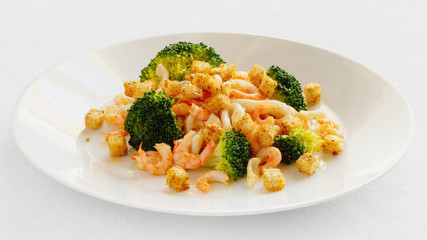 marinated in lemon juice seafood fried in garlic oil with steamed broccoli and croutons