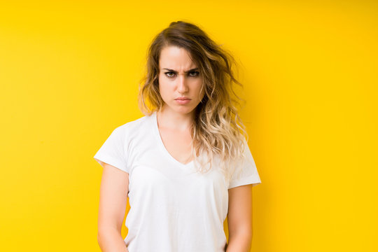 Young beautiful blonde woman over yellow background skeptic and nervous, frowning upset because of problem. Negative person.