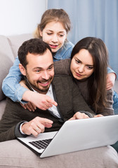 Parents and daughter happy to book hotel online together at home