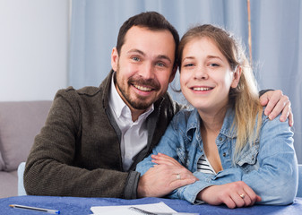 Father helping daughter with homework