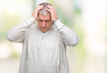 Handsome senior man wearing sport clothes over isolated background suffering from headache desperate and stressed because pain and migraine. Hands on head.