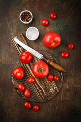 Naklejka na ściany i meble Close up knife and tomato on wooden table