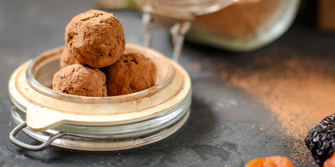 candy dressing  cocoa (dried fruit filling) sweets on a dark background. Top view. copy space