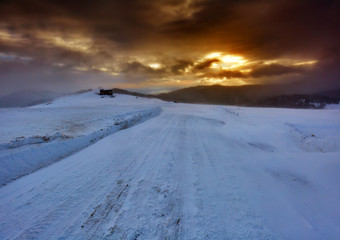Fototapeta na wymiar Snowy road in the mountains