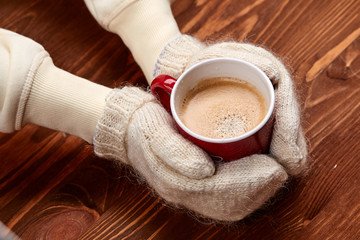 hands holding cup of coffee