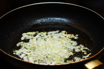 Frying chopped onions in a pan, cooking