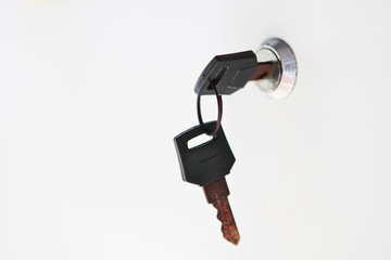 Small keys with rust in keyhole on white background. Objects on a white background.