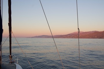 Mediterranean sea sunset view to coast from sailing yacht