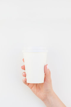 Mock up of coffee cup in female hand