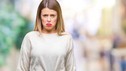 Young beautiful woman casual white sweater over isolated background depressed and worry for distress, crying angry and afraid. Sad expression.