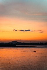 sunset at the sea with long tail boat 