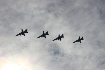 planes in flight, against the cloudy sky