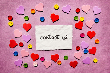 Contact us - text on pink background with colorful hearts decorations