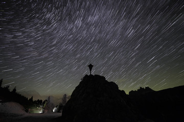 mountain star trail with religious symbol in the foreground.