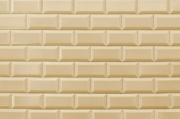 Old beige tile brick wall background texture