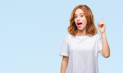 Fototapeta premium Young beautiful woman over isolated background pointing finger up with successful idea. Exited and happy. Number one.