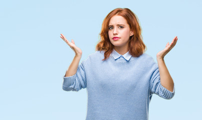 Young beautiful woman over isolated background wearing winter sweater clueless and confused...