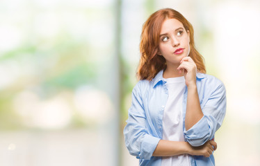 Fototapeta premium Young beautiful business woman over isolated background with hand on chin thinking about question, pensive expression. Smiling with thoughtful face. Doubt concept.