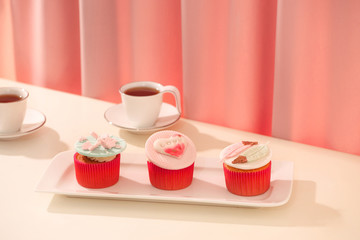 Many yummy cupcakes. Valentine sweet love cupcake on table on light background