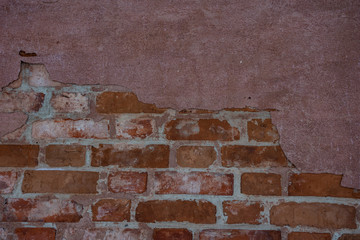 Texture of red brickwork with peeled white paint