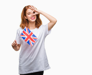 Young beautiful woman holding flag of united kingdom over isolated background with happy face smiling doing ok sign with hand on eye looking through fingers