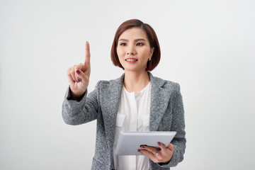 Adult professional woman in jacket with tablet pointing finger on air