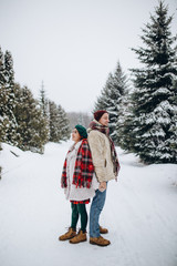 Fototapeta na wymiar Beautiful young people couple lovers on a date in winter park , a man loves a woman a date Valentine's Day in nature.