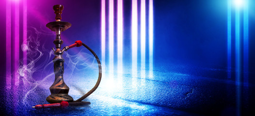 Hookah smoking on a concrete background, illuminated by the spotlight, neon light, smoke