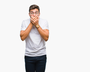 Fototapeta premium Young handsome man wearing glasses over isolated background shocked covering mouth with hands for mistake. Secret concept.