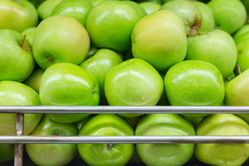 green apple on the supermarket shelf, displayed for sale