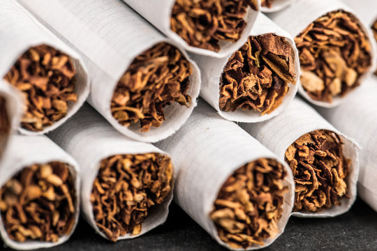 Close-up of tobacco cigarettes on a black background.