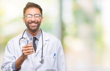 Adult hispanic doctor man drinking glass of water over isolated background with a happy face...