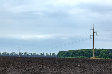 Fototapeta na wymiar plowed agricultural field with black earth soil