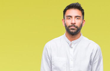 Fototapeta premium Adult hispanic man over isolated background with serious expression on face. Simple and natural looking at the camera.