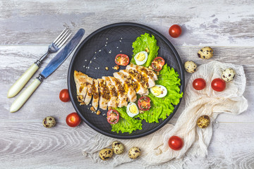 Chicken with honey and mustard souse, lettuce, quail eggs, cherry tomatoes