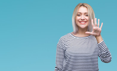 Young blonde woman over isolated background showing and pointing up with fingers number five while...